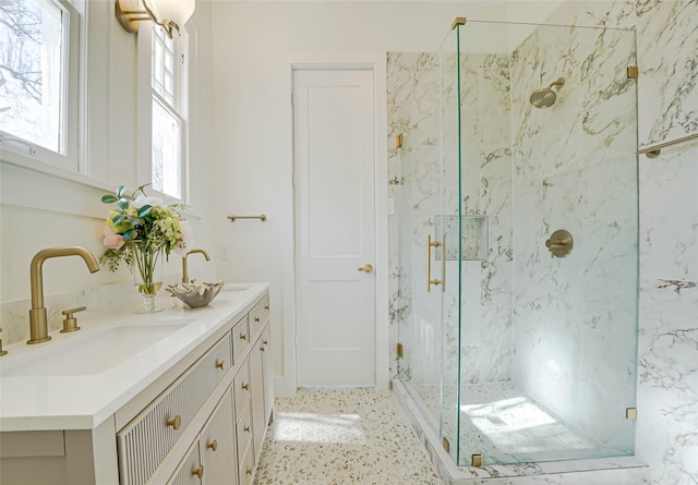 bathroom featuring a marble finish shower and vanity