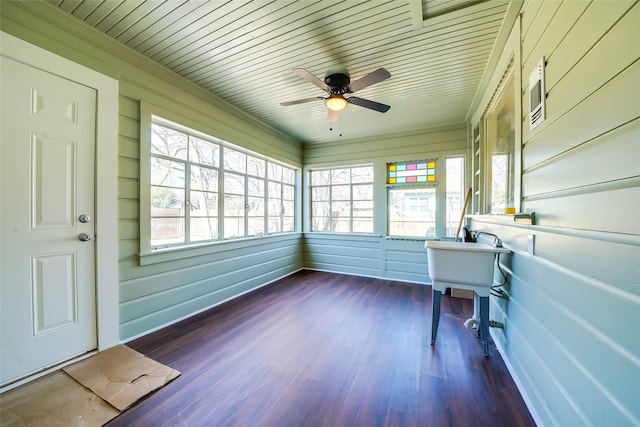 unfurnished sunroom with wood ceiling and a ceiling fan