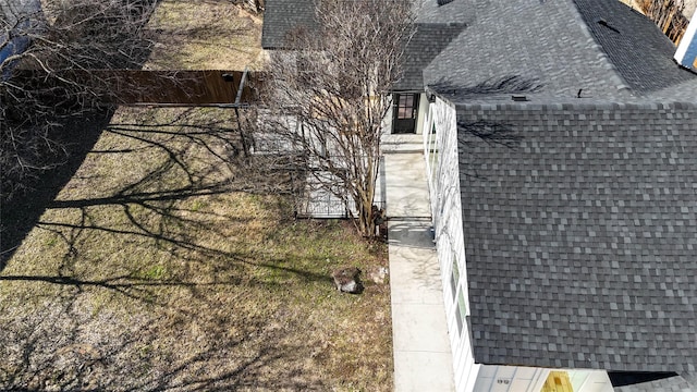 exterior space featuring a shingled roof