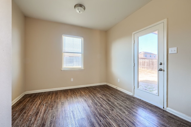 empty room with dark hardwood / wood-style flooring