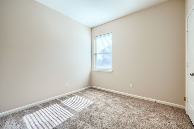 unfurnished room featuring light carpet