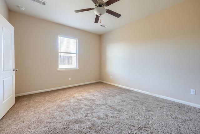 empty room featuring carpet floors and ceiling fan