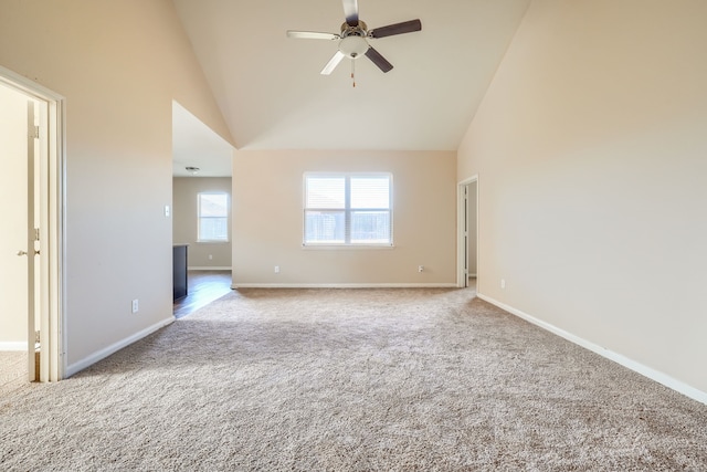 empty room with ceiling fan, carpet flooring, and high vaulted ceiling