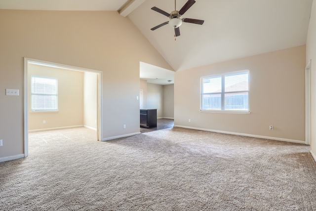 unfurnished living room with beam ceiling, high vaulted ceiling, light colored carpet, and a healthy amount of sunlight