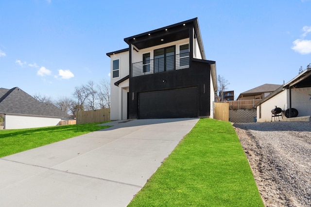 modern home with a balcony, a garage, and a front lawn