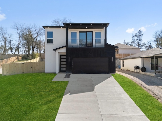 contemporary home featuring a garage, a balcony, and a front yard