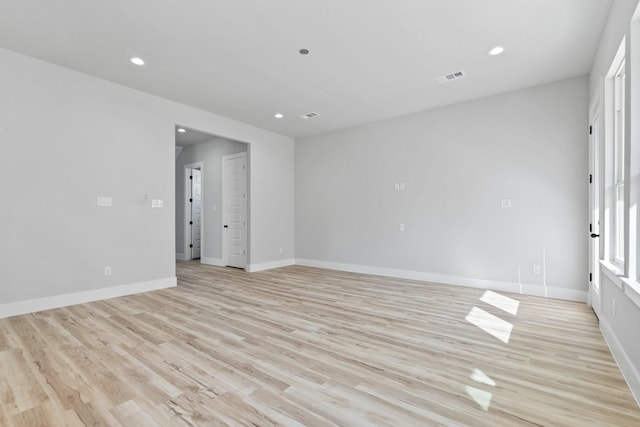 empty room with light hardwood / wood-style flooring