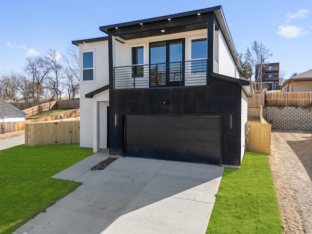 contemporary home with a garage and a front lawn