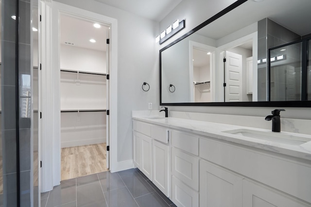 bathroom with vanity, tile patterned floors, and walk in shower