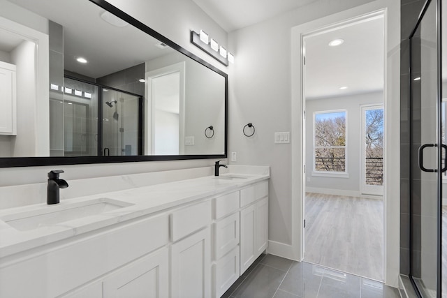 bathroom with vanity, a shower with door, and tile patterned floors