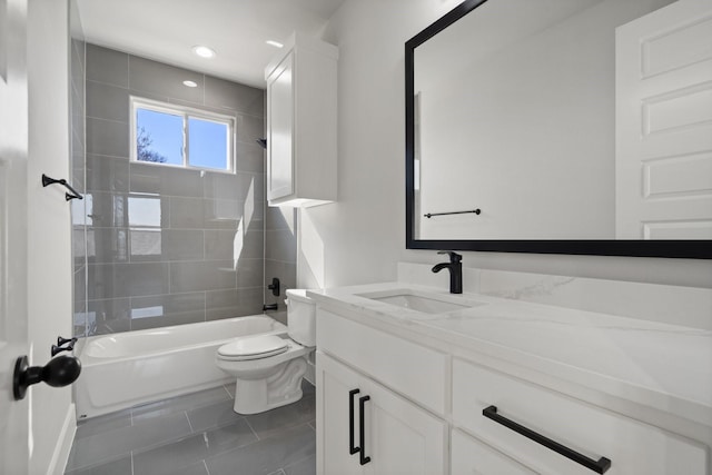 full bathroom with vanity, tile patterned flooring, tiled shower / bath combo, and toilet