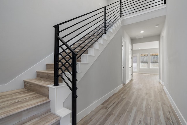 stairway featuring wood-type flooring