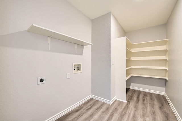 laundry area with hardwood / wood-style flooring, hookup for a washing machine, and electric dryer hookup