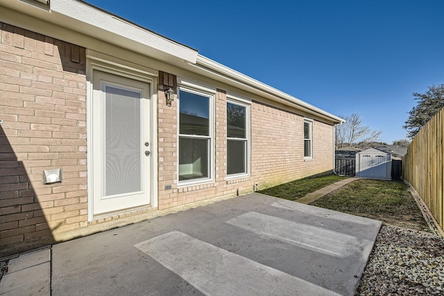 view of exterior entry with a patio