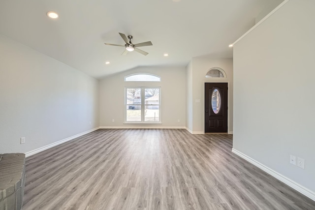 entryway with ceiling fan, lofted ceiling, and light wood-type flooring