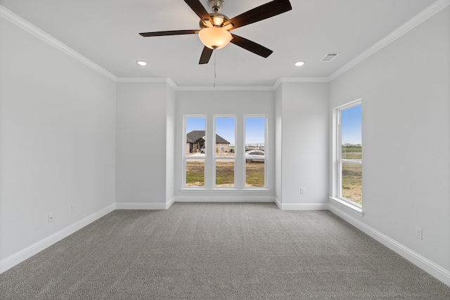 carpeted spare room with crown molding and ceiling fan