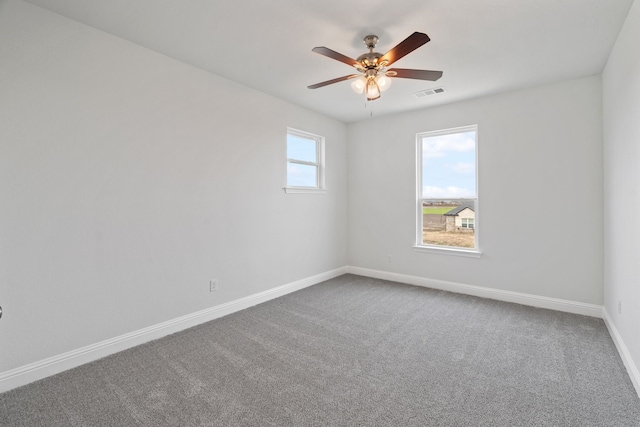 spare room with ceiling fan, a healthy amount of sunlight, and carpet floors