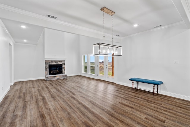 unfurnished living room featuring dark wood-type flooring, a fireplace, and ornamental molding