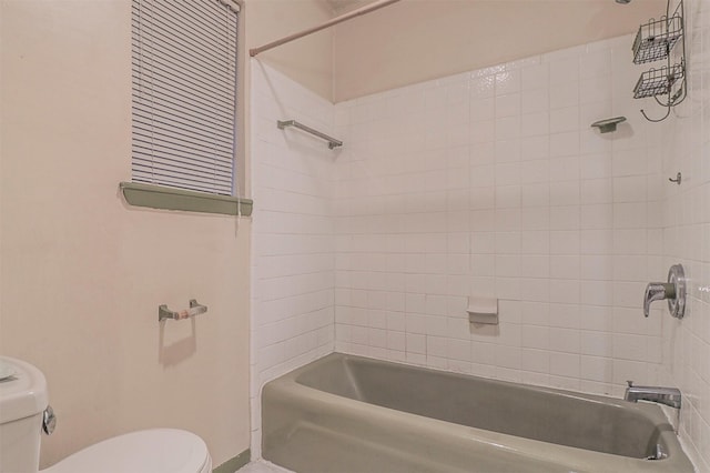 bathroom featuring shower / washtub combination and toilet