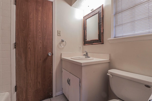 bathroom with vanity, toilet, and tile patterned flooring