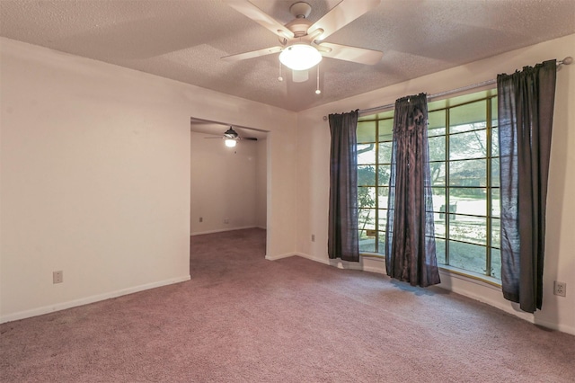 spare room with ceiling fan, a healthy amount of sunlight, carpet, and a textured ceiling