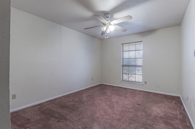 carpeted spare room with ceiling fan and a textured ceiling