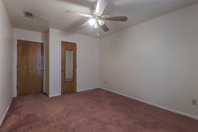 unfurnished bedroom with ceiling fan, carpet flooring, a closet, and a textured ceiling