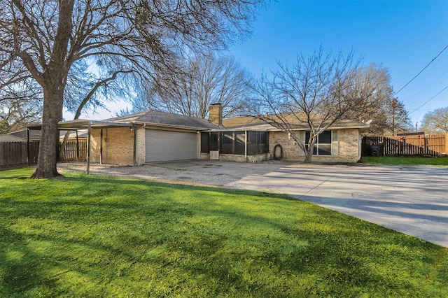 ranch-style house featuring a garage and a front yard