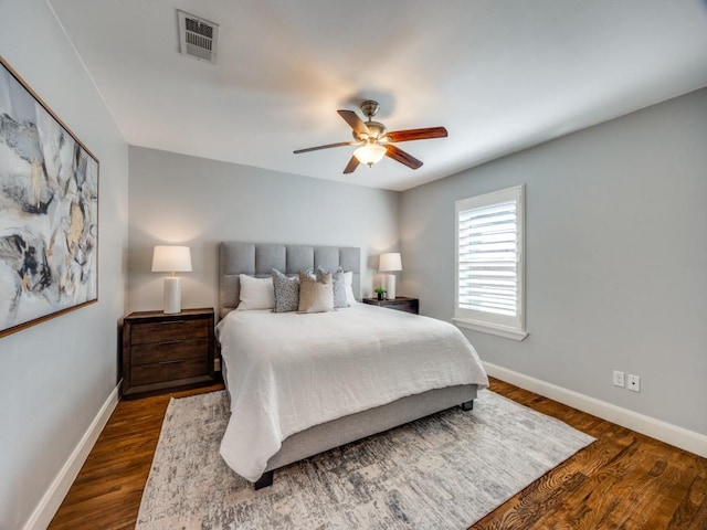 bedroom with dark wood-type flooring and ceiling fan