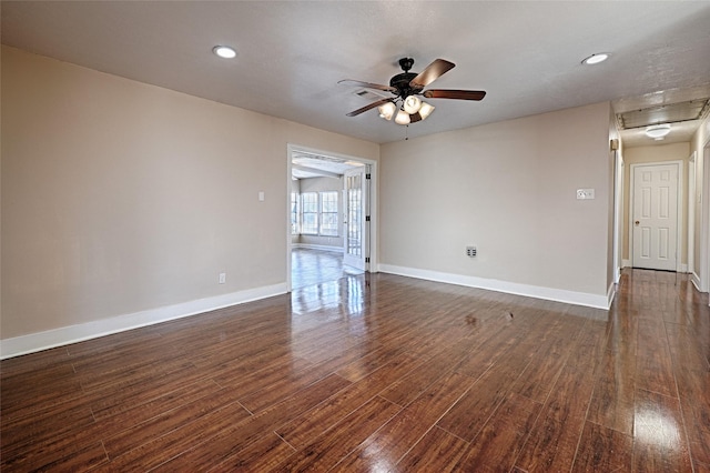 empty room featuring dark wood-type flooring and ceiling fan