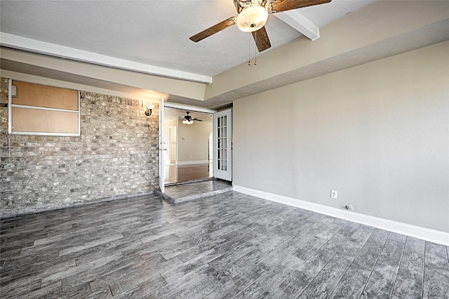 empty room featuring ceiling fan and beamed ceiling