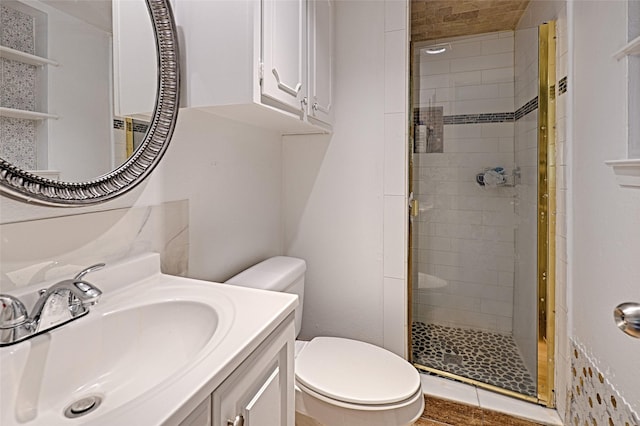 bathroom featuring vanity, toilet, and walk in shower