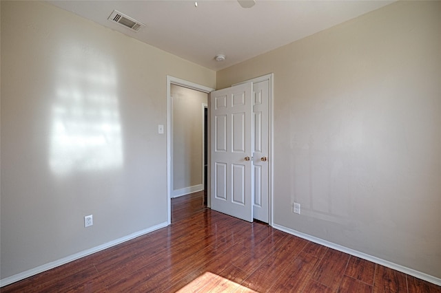 spare room with dark hardwood / wood-style flooring