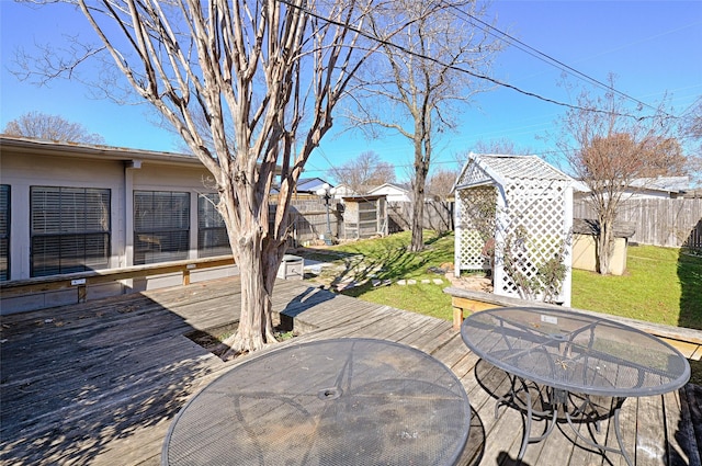 exterior space featuring a storage unit and a deck