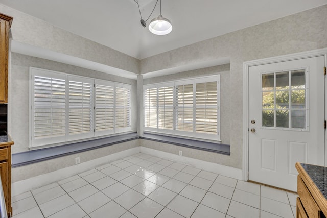 unfurnished dining area featuring light tile patterned flooring