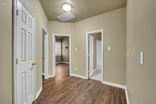 corridor with dark hardwood / wood-style floors