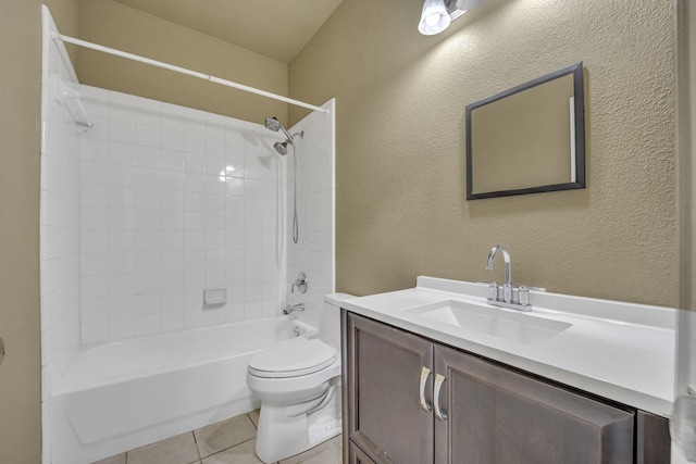 full bathroom featuring tile patterned flooring, vanity, tiled shower / bath, and toilet