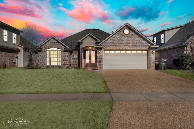 view of front of home featuring a garage and a lawn