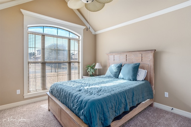 carpeted bedroom with crown molding, lofted ceiling, and ceiling fan