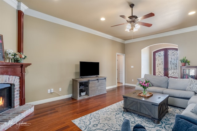 living room with dark hardwood / wood-style flooring, crown molding, french doors, and ceiling fan