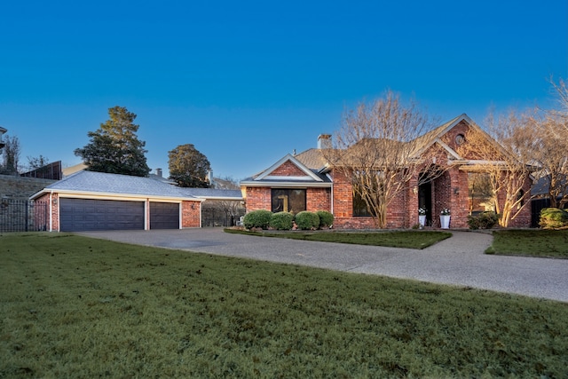 view of front of property with a garage and a front lawn