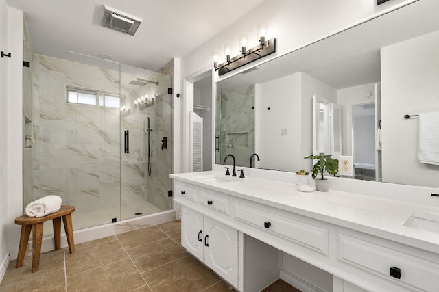 bathroom featuring vanity, a shower with shower door, and tile patterned floors