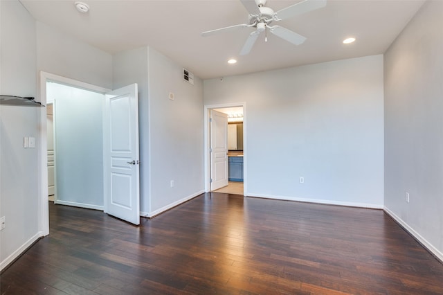 interior space with connected bathroom, dark hardwood / wood-style floors, and ceiling fan