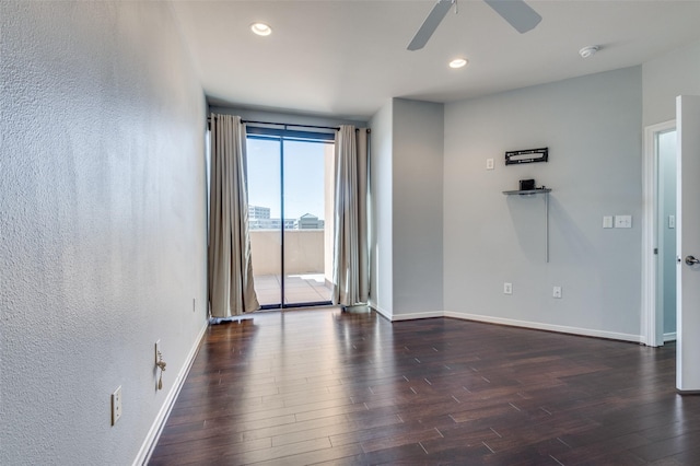 empty room featuring dark hardwood / wood-style floors and ceiling fan