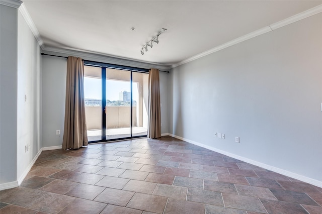 empty room featuring track lighting and ornamental molding