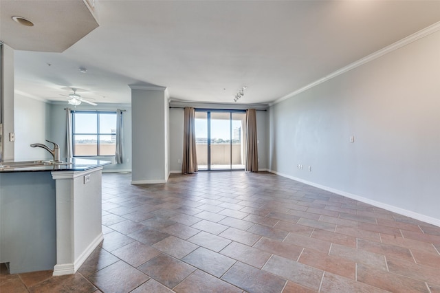 interior space featuring crown molding, plenty of natural light, sink, and ceiling fan