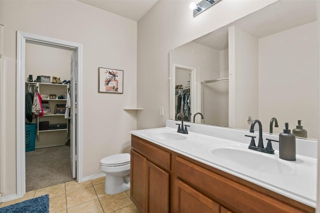 bathroom featuring tile patterned flooring, vanity, and toilet