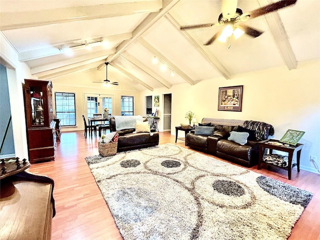 living area with light wood-style flooring, baseboards, lofted ceiling with beams, and ceiling fan