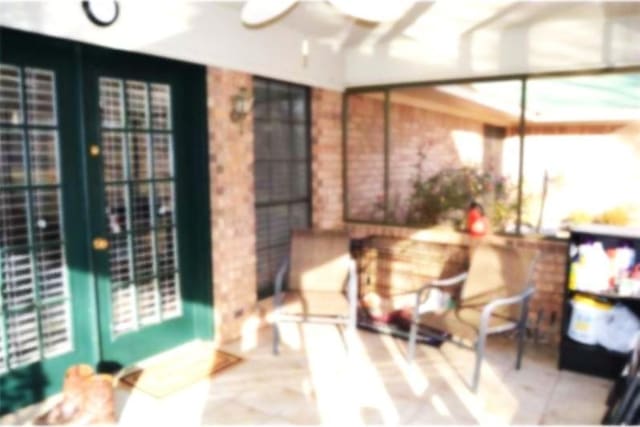 sunroom / solarium featuring ceiling fan