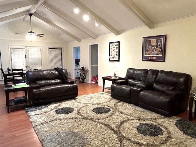 living room featuring ceiling fan, rail lighting, hardwood / wood-style floors, and vaulted ceiling with beams